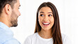 © Olga - Woman smiling and talking with man face to face