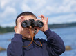 © light - Close-up of child using binoculars on the sea beach