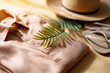 © maria_lh - Minimalist flat lay tropical summer fashion set. Eco shirt, hat, flip flops, leaf shadow on beige background