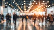 © PixelPulse - Blurred Crowd at Business Convention People Flowing Through Exhibition Hall