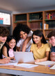 © CarlosBarquero - Vertical. Five diverse high school students are smiling and working together on a project in the library, using a laptop and taking notes, demonstrating teamwork and collaboration in education