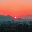 © Ahmad - Cityscape sunset over mountains, urban panorama, tranquil evening, potential travel poster