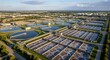 © Margarita Ratatosk - Aerial view of a modern urban wastewater treatment plant facility. Industrial water purification process for environmental protection ecology.
