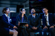 © ultramansk - A diverse team of AI strategists in a project huddle, reviewing a neural network design on a tablet. A concept for agile development, collaborative problem-solving, and tech innovation.