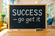 © H Ray - 'Success - Go Get It' message on a blackboard in a bright room.