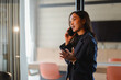 © PaeGAG - Asian businesswoman talking on smartphone and gesturing in modern office