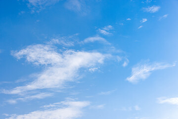 Wall Mural - the sky is clear and bright and the clouds are scattered throughout the sky. blue sky with white clouds.