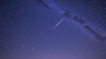 Wall Mural - a mesmerizing video of a starry night sky, captured from a low-angle view, showcasing the milky way'