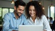 © MT Studio - Happy couple working together on laptop in modern office environment indoor