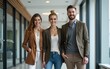 © li - Full-length photo of positive young coworkers in office building. High quality