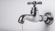© Ima - Water flows from a chrome faucet.