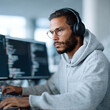 © SolaruS - Focused coder in hoodie, immersed in complex code on dual monitors, wearing headphones. Represents tech, innovation, problemsolving  modern work.