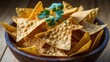 © Lasvu - A bowl of tortilla chips garnished with cilantro.