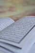 © Firman Maulana Ihsan - A close-up of an open Al-Quran, the holy book of Islam, showing its beautiful Arabic script and calligraphy. This image represents prayer, worship, study, and spiritual devotion, especially during Ram