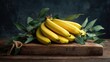 © lumpia - Bunch of bananas on rustic wooden board with eucalyptus leaves