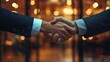 © Ahmad - Close-up of two people shaking hands.
