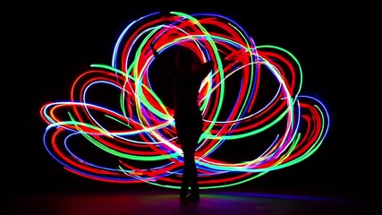 Wall Mural - Dynamic Light Painting Performance: Abstract Art with Vibrant Red, Green, and Blue Light Trails in