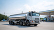 © Kateryna - Fuel tanker truck with multiple compartments and safety equipment delivering petroleum products to gas station demonstrating energy distribution and retail supply chains fuel log