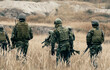 © zignalstudio - Ukraine-8 Jun 2025-Armed soldier in camouflage with weapon shows special signal.Young military man soldier holding gun, wearing special services uniform, stand in smoky space. defend concept.