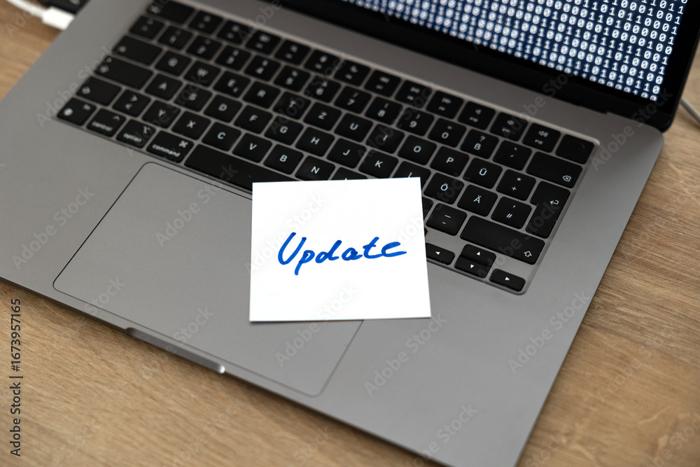 Computer software updates, note on the keyboard of a laptop. Technology ...