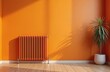 © Vadym - Orange radiator heats room. Metal object on wall provides warmth and energy. Home interior design feature for comfortable living. Modern heating equipment with clean lines.