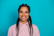 © deagreez - Charming young woman with braided hair in striped pink shirt smiling against vibrant blue background