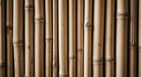 Close-up of natural dried bamboo stalks forming a textured background, showcasing their organic pattern and earthy tones