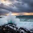 © bangku - Turbulent ocean wave crashing on jagged volcanic rock coast at sunset