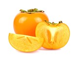 Ripe persimmons showcasing vibrant orange color with sliced segments on white surface