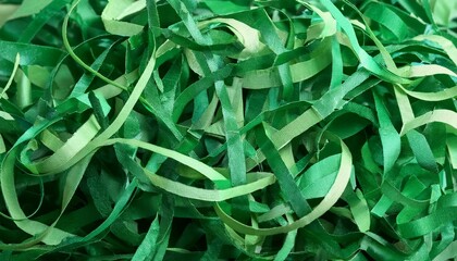 Wall Mural - shredded green paper decorations used for crafts and gift wrapping suitable for various occasions like parties or holidays