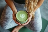 Woman in yoga outfit holding matcha latte