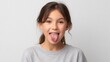 © Kliapko_Photo - Girl sticking tongue out with playful face mischievous or silly expression isolated