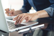 © tippapatt - Closeup, business woman's hands working and typing on laptop computer keyboard on office table. Woman or student using laptop for online studying, internet marketing,  work from home