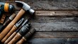 © Bruce - Carpentry tools like a hammer, tape measure, and wooden planks neatly arranged on a rustic wooden table with blank space for branding or promotional text, perfect for DIY.