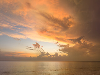 Wall Mural - aerial view amazing cloud in colorful sky at sunset above the ocean.
the sea water reflected from the sky.
Majestic sunset landscape Amazing light of nature.
beautiful sunset cloudscape background.