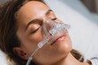 © Pavel - Woman receiving molecular hydrogen therapy with specialized equipment for enhanced wellness and recovery in a clinical setting