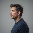 © Cathy - Handsome mature man in sweater profile view looking ahead against a solid color studio shot