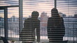 © stockbusters - Marketing agency team silhouettes working at evening panorama cabinet closeup