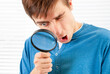 © Sabphoto - Surprised Man with a Magnifying Glass