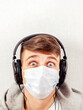 © Sabphoto - Surprised Young Man in Flu Mask