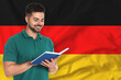 © New Africa - Teacher or student with book against flag of Germany. Language school