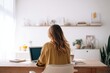 © somebody_is_me - A young woman sits at a wooden desk with her laptop in a bright, sunlit home office. The minimalist setting with soft tones creates a calm and productive workspace.