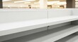 © Max Graphic - Clean empty white shelves in a modern retail store, symbolizing new beginnings, scarcity, or inventory issues