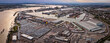 Wide-angle aerial image of the Port of London, showing industrial shipping activity, warehouses, and container docks. Ideal for logistics, maritime trade, transport, economy, and infrastructure themes