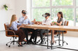 © Pixel-Shot - Young business colleagues using VR glasses at table in office