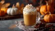 © Snowstudio - Pumpkin spice latte hot drink topped with whipped cream and cinnamon on autumn background