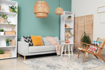 Wall Mural - Interior of stylish living room with grey sofa, table and shelf units