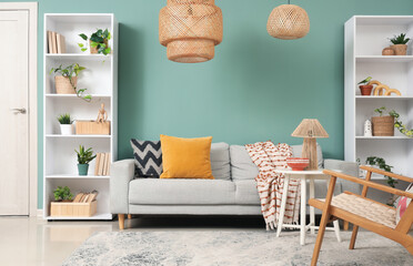 Wall Mural - Interior of stylish living room with grey sofa, table and shelf units