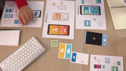 Wall Mural - excellent startup company employee presenting user interface prototype for mobile application to sma