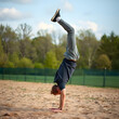 © Lauren - young man throwing a somersault outdoors, full length side view photo, copy space